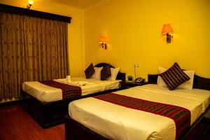 Una cama o camas en una habitación de Hotel Bougainvillea