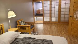 a bedroom with a bed and a chair and a window at Nine Valley Park in Boeun +50 photos
