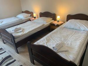 A bed or beds in a room at Aranykorona Hotel