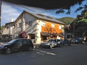 a group of cars parked in front of a building at Hosteria Laura in San Martín de los Andes