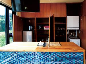 a kitchen with a island with a counter top at CHULAX OKINAWA YOMITAN【Designer Condominium Hotel】 in Yomitan