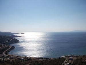 a view of the ocean with a boat in the water at Monolithos Villas in Kipri