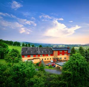 an aerial view of a building with trees at Ferienhotel Goldhübel in Neuhausen