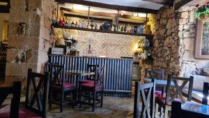 eine Bar mit Stühlen und einem Tisch in einem Restaurant in der Unterkunft Palacete Maria Rosa in Baños de la Encina