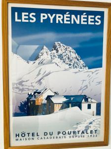 a sign on a wall in front of a snow covered mountain at Résidence Thibaud in Toulouse