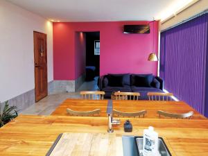 a living room with a couch and a table at CHULAX OKINAWA YOMITAN【Designer Condominium Hotel】 in Yomitan