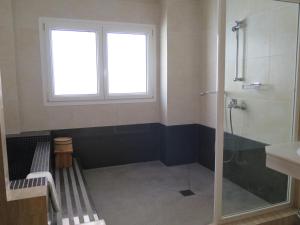 a bathroom with a shower and a sink and a window at La Luna Blanca in Torremolinos