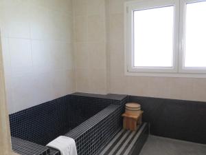 a bathroom with a bath tub with a toilet at La Luna Blanca in Torremolinos