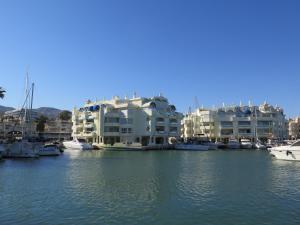 a group of houses and boats in a marina at La Luna Blanca in Torremolinos