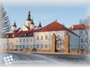 a large white building with a red roof at Pokoje Gościnne Domu Pielgrzyma w Supraślu in Supraśl