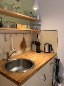 a kitchen with a sink and a counter top at B&B Pakhuis Emden in Groningen