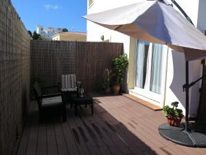a patio with a table and an umbrella at La Luna Blanca in Torremolinos