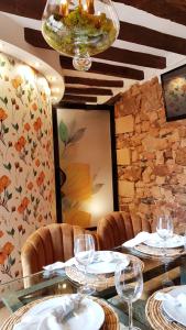 uma sala de jantar com uma mesa e cadeiras e um lustre em Palacete Maria Rosa em Baños de la Encina