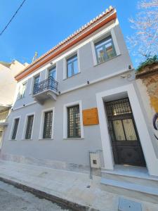 una casa blanca con una puerta negra en Twin Circle Athens, en Atenas