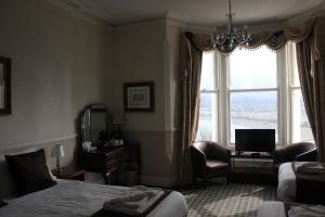 a hotel room with a bed and a window at Headlands Hotel in Llandudno