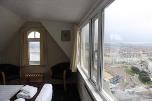 a hotel room with a view of a city from a window at Headlands Hotel in Llandudno