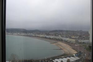 a view of a beach with buildings and a city at Headlands Hotel in Llandudno
