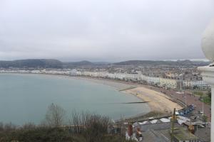 a view of a beach with buildings and a city at Headlands Hotel in Llandudno