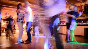 a group of people dancing at a bar at Ferienhotel Goldhübel in Neuhausen