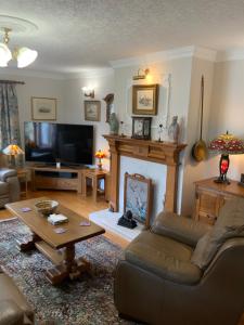 a living room with a couch and a fireplace at Remarkable 2-Bed Cottage in tranquil setting in Wooler