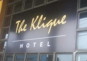 a sign for a hotel on the side of a building at Klique Hotel Eldoret in Eldoret