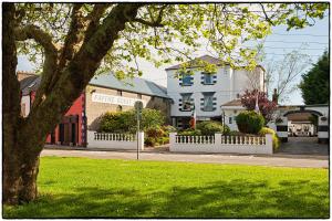 una strada con una recinzione bianca e un edificio di Faythe Guesthouse a Wexford
