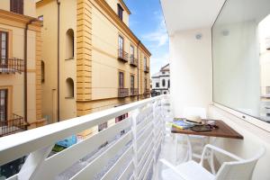 - Balcón con mesa y sillas en un edificio en Hotel Tasso Suites & Spa, en Sorrento