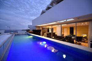 a house with a swimming pool at night at Private pool Luxury penthouses sea view Eilat in Eilat