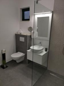 a bathroom with a toilet and a sink and a shower at Villa Diamond in Žrnovnica +46 photos