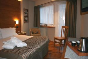 Ένα ή περισσότερα κρεβάτια σε δωμάτιο στο Hotel Larice Bianco