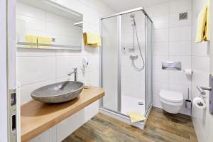 a bathroom with a sink and a shower at Landgasthof zur Sonne in Emmingen-Liptingen