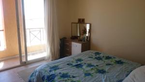 a bedroom with a bed and a dresser and a window at العين السخنة لاڤيستا توباز in Ain Sokhna +22 photos