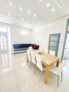 a dining room with a wooden table and white chairs at LUXURY apartment in the centre with a place for barbecue party in Budapest