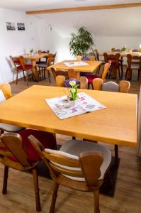a dining room table with chairs and tables at Haus Kranzusch in Sonthofen