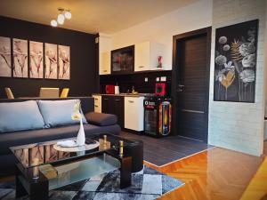 a living room with a couch and a table at Apartman Aurelius - private parking in Osijek