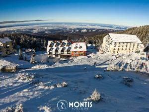 an aerial view of a resort in the snow at Montis Hotel & Spa in Muntele Mic