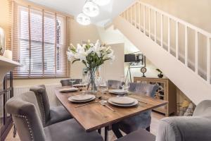 a dining room with a wooden table and chairs at Chester City Centre Cottage, Sleeps 6 with FREE Parking in Chester