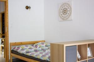 a bedroom with a bed and a table at Szkocka 4 Apartamenty in Gdańsk