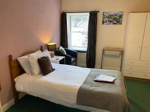 Ένα ή περισσότερα κρεβάτια σε δωμάτιο στο The Fountain Hotel