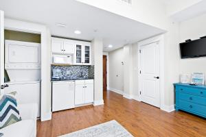 
a kitchen with a stove, refrigerator, sink and cabinets at Sandestin Baytowne Wharf - Observation Point South #471 in Destin
