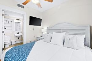 
a hotel room with a bed and a television at Sandestin Baytowne Wharf - Observation Point South #471 in Destin
