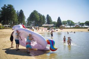 a group of people standing on a beach with a large at Arden Parks Tulderheyde in Poppel