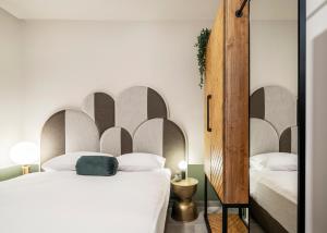 a bedroom with a bed with a large headboard at Mr. Agrippa - By TLV2GO in Jerusalem