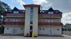 a large building with balconies on top of it at Margaréta Apartmanház in Balatonlelle