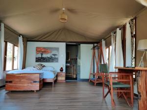 a bedroom with a bed in a tent at Oldonyo Orok Lodge in Kajiado