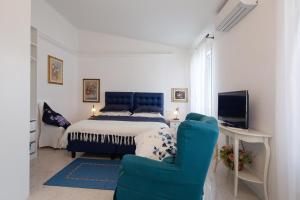 a bedroom with a bed and a blue chair at Come Eravamo in Monterosso al Mare