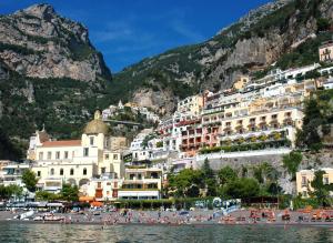 
a scenic view of a city with houses and boats at Buca Di Bacco in Positano
