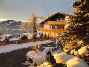 a house covered in snow in front at Haus Panorama in Oy-Mittelberg