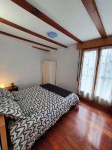 a bedroom with a bed and a wooden floor at Gernika Urdaibai in Guernica y Luno