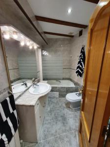 a bathroom with a sink and a tub and a toilet at Gernika Urdaibai in Guernica y Luno